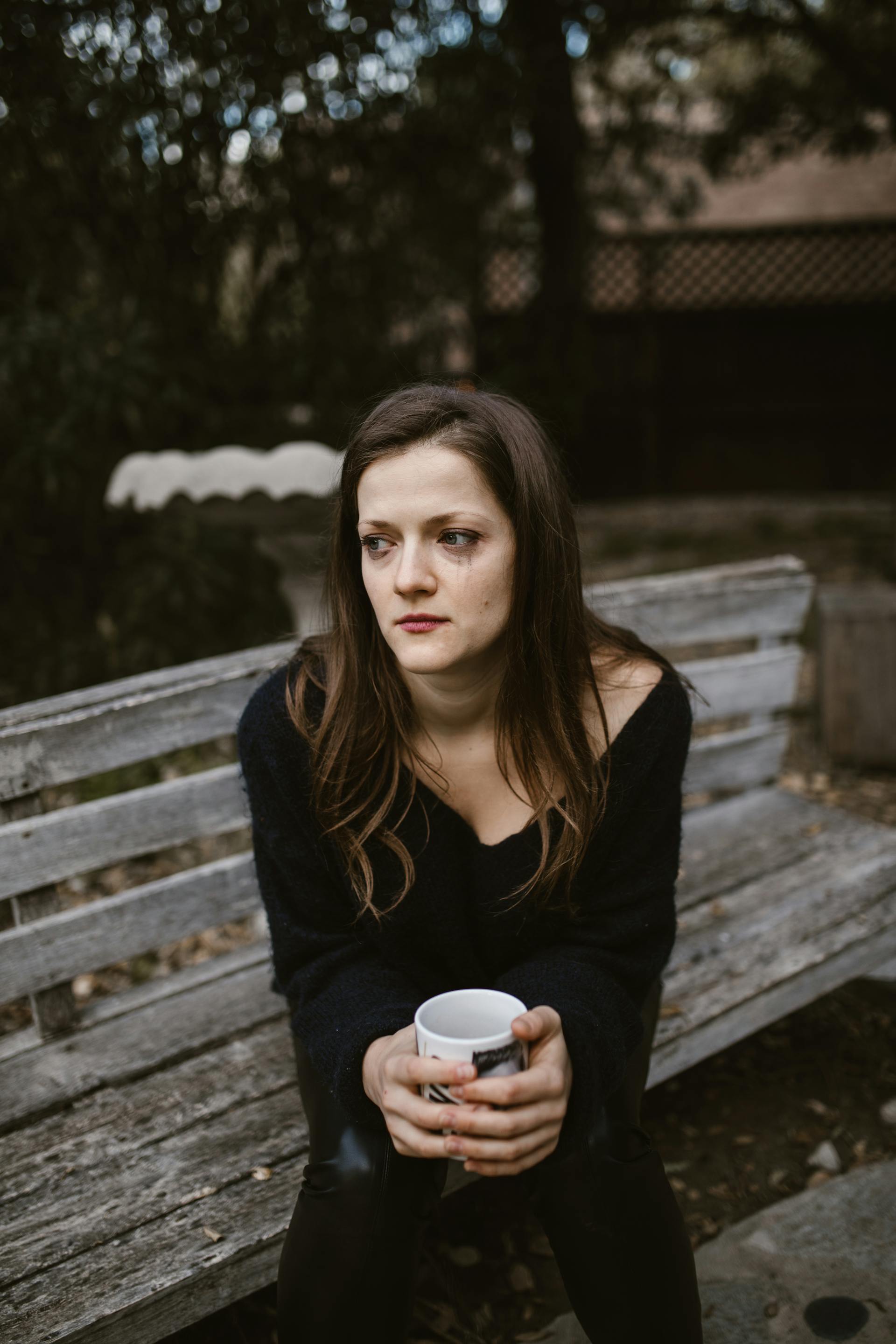 A crying woman holding a mug | Source: Pexels